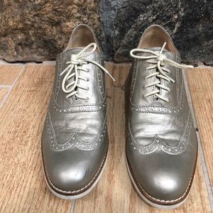Cole Haan Wingtip Oxfords in gold metallic.